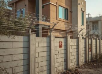 A modern Pakistani house with a strong boundary wall fitted with an electric fence system,